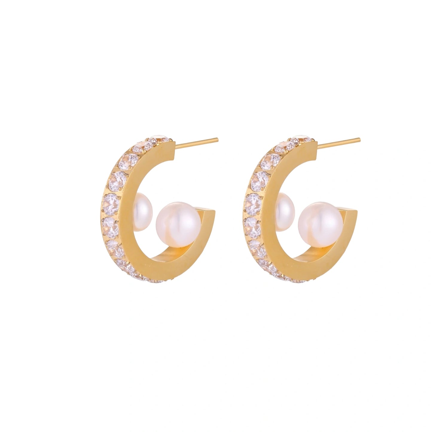 Gold hoop earrings with pearls and clear stones on a white background