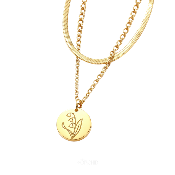Gold birth flower coin pendant necklace on white background