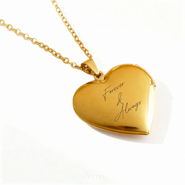 Gold engravable heart locket necklace on white background