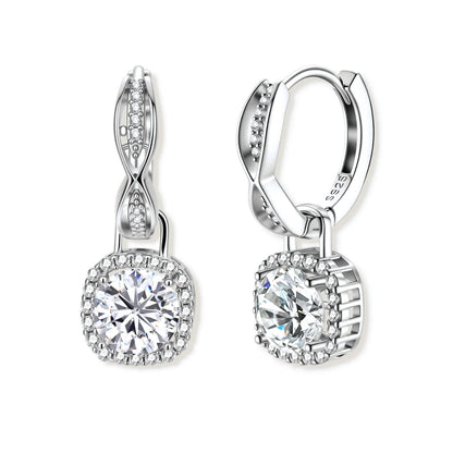 Freya Twist Halo Moissanite Earrings, pair of twisted huggie hoops each with a round moissanite in a cushion-shaped pavé halo, front view