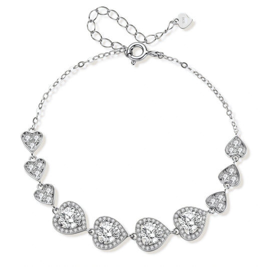 Colette Heart Moissanite Bracelet, linked heart stations with four round moissanites in pavé halos on a fine chain, laid in a circle showing the spring-ring clasp and extender