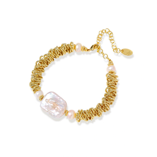 Gold bracelet with pearls on a white background