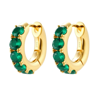 Gold hoop earrings with green gemstones on a white background