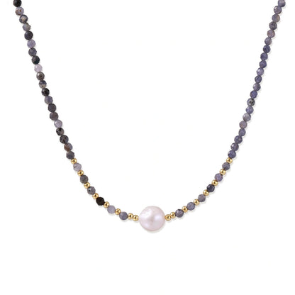 Thea Iolite Pearl Necklace, strand of faceted blue-grey iolite beads with a single white freshwater pearl and gold spacer beads, front view