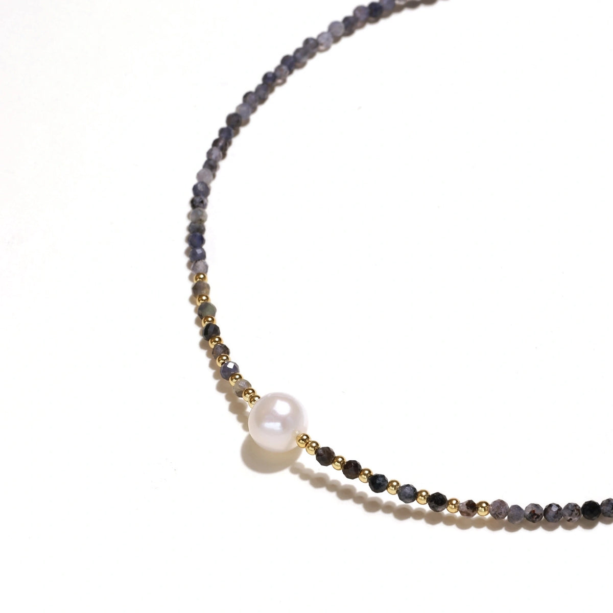 Thea Iolite Pearl Necklace, close view of the centre pearl between the iolite beads
