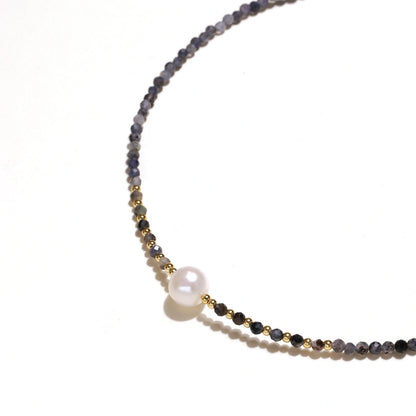 Thea Iolite Pearl Necklace, close view of the centre pearl between the iolite beads