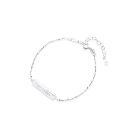 Noor Pearl Bar Bracelet, fine silver chain bracelet with a single elongated white pearl, laid flat in a circle showing the spring-ring clasp and extender