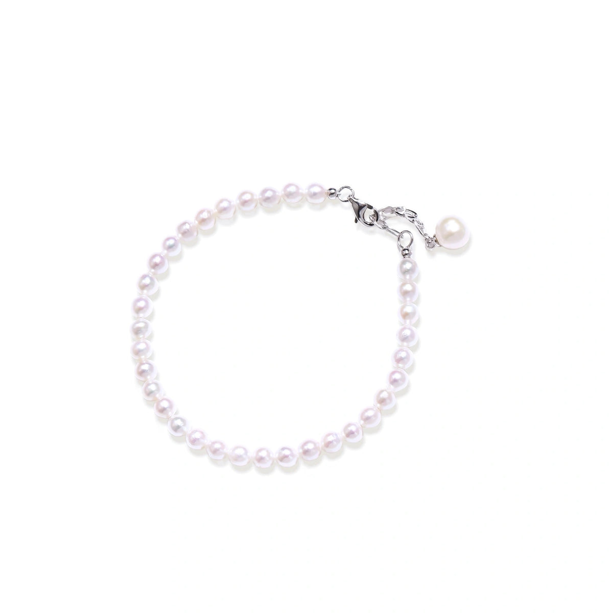 Mira Pearl Strand Bracelet, strand of small white freshwater pearls with a lobster clasp, extender chain and single pearl charm, laid flat in a circle