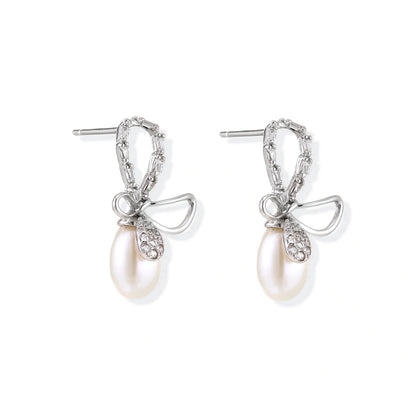Bettina Bow Pearl Drops, pair angled to show the stone-set bow loop, the polished loop and the post backs