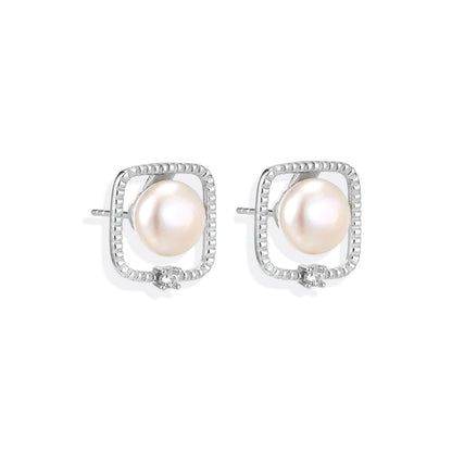 Greta Pearl Frame Studs, pair side by side showing the textured open frames