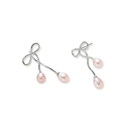 Nell Bow Pearl Earrings, pair lying at an angle showing the post backs and pearl drops