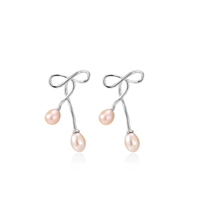 Nell Bow Pearl Earrings, pair of bow-and-pearl earrings side by side, front view