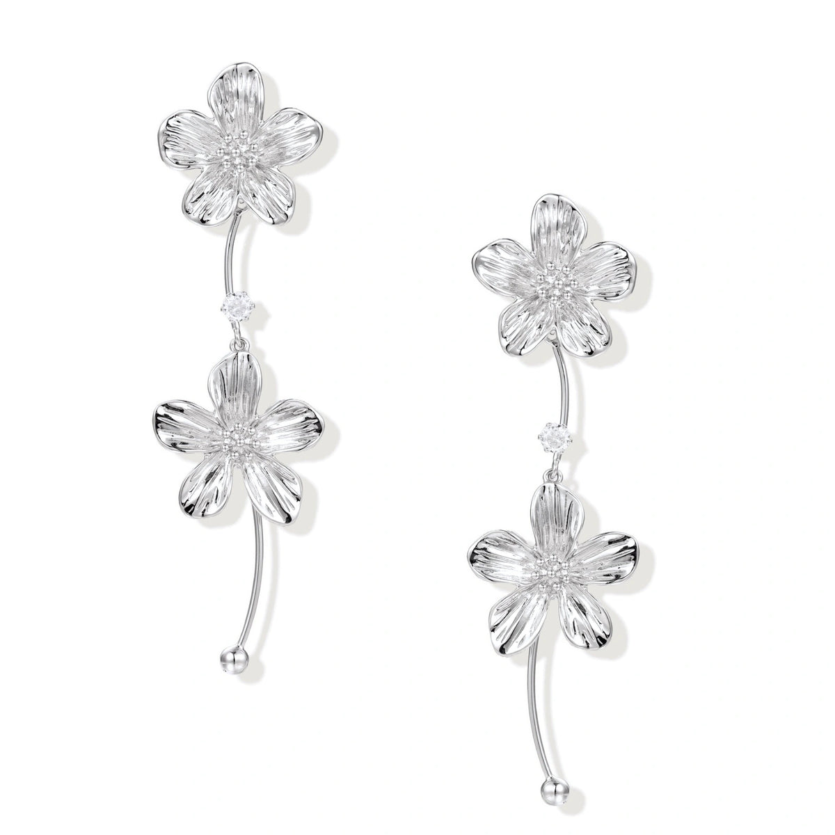 Bloom Cascade Earrings, front view of the asymmetric white gold-plated flower cascade with zirconia accent