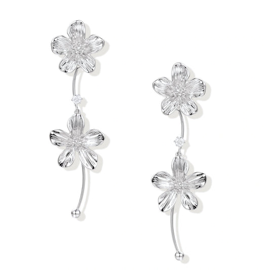 Bloom Cascade Earrings, front view of the asymmetric white gold-plated flower cascade with zirconia accent