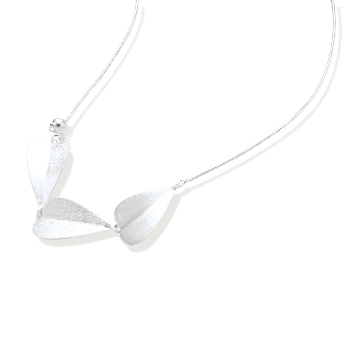 Lark Leaf Necklace, close view of the three brushed leaves