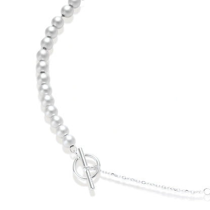 Della Sphere Necklace, close view of graduated brushed silver spheres and the toggle clasp on a fine chain