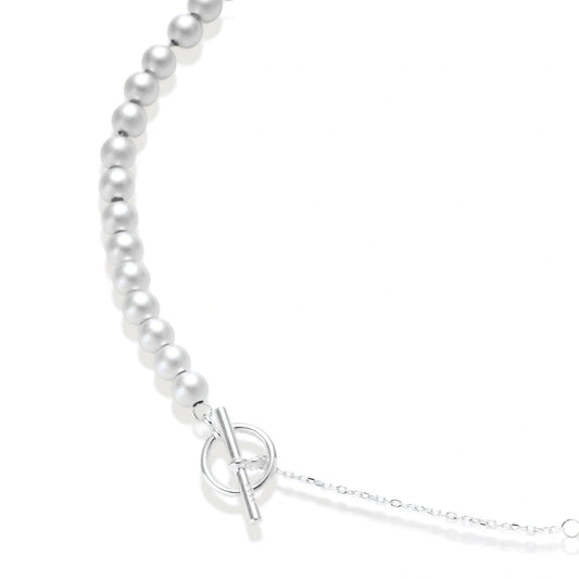 Della Sphere Necklace, close view of graduated brushed silver spheres and the toggle clasp on a fine chain