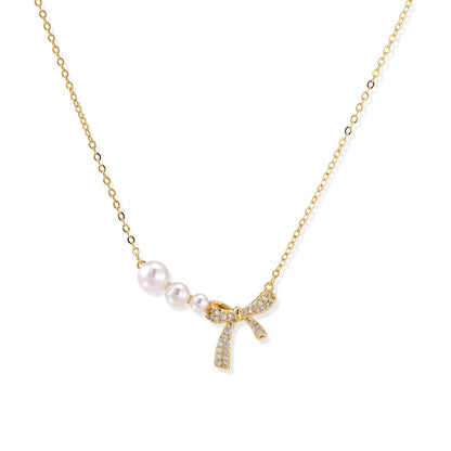 Pearl Bow Dreams Necklace - 14K Gold Plated Brass with freshwater pearls and pavé crystal bow, front view