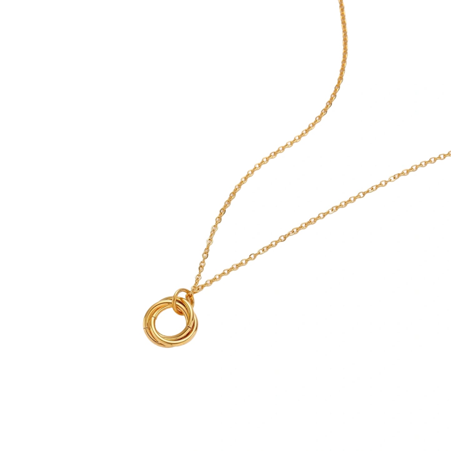 Gold necklace with a circular pendant on a white background
