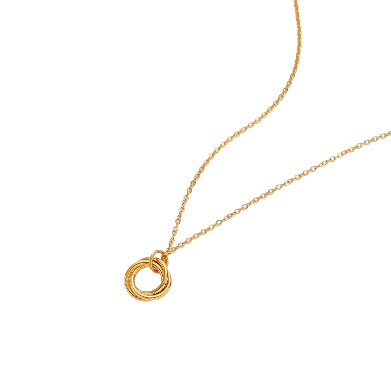 Gold necklace with a circular pendant on a white background