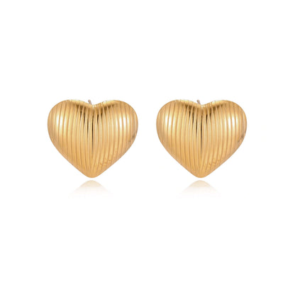Textured Heart Stud Earrings side view showing domed ribbed surface