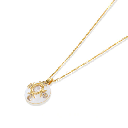 Golden Medallion Necklace, close-up of the pave zirconia cardinal point motifs