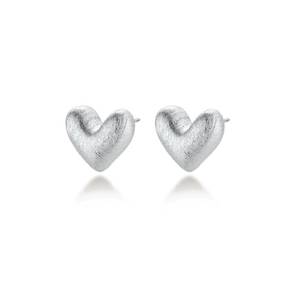 Hazel Silver Heart Studs, pair angled to show the rounded heart profile and posts