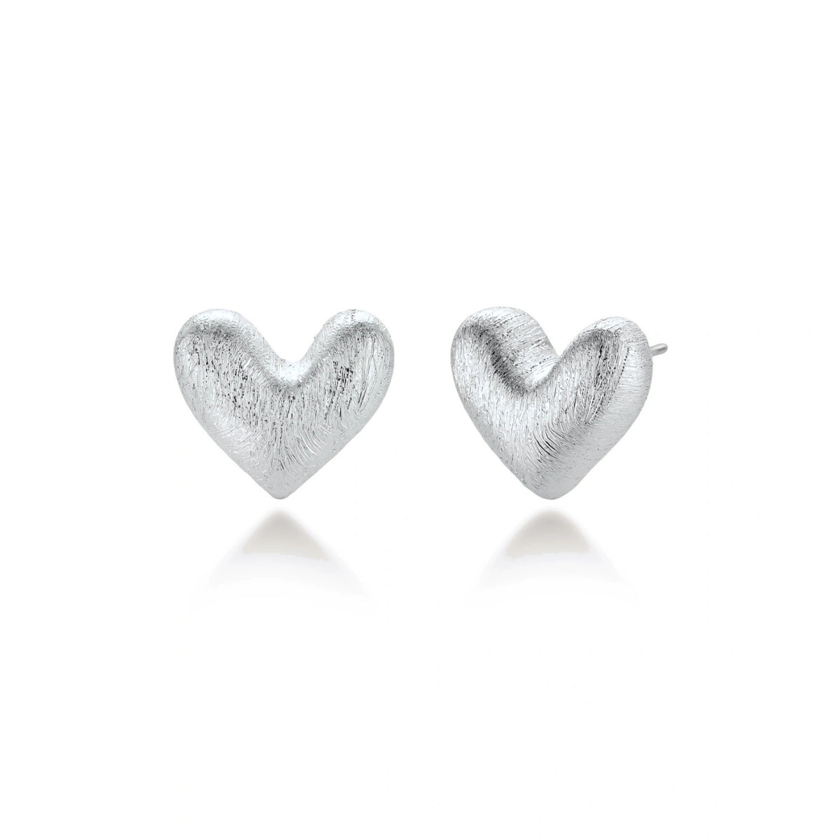 Hazel Silver Heart Studs, pair of brushed silver puffed heart stud earrings, one front-on and one turned to show the post