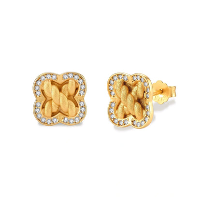 Ines Clover Studs, pair of gold four-leaf clover studs with braided centre and cubic zirconia border, angled front view, posts visible