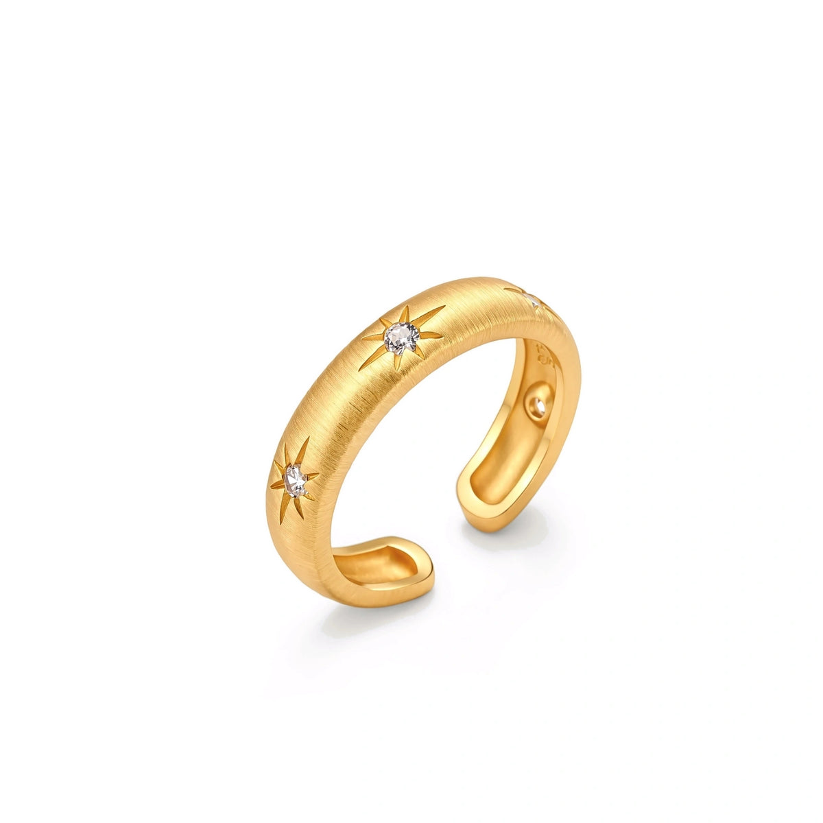 Astra Cuff Ring, brushed gold open cuff ring standing upright, angled view showing two starburst-set cubic zirconia and the open back