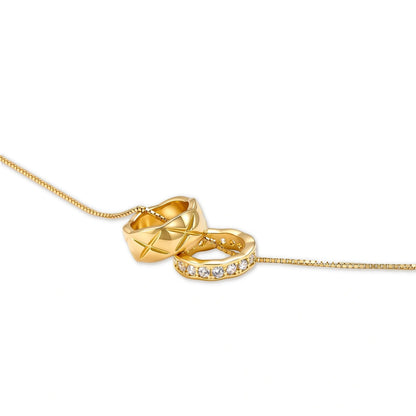 Gemma Twin Ring Necklace, close view of the quilted star-etched ring and the cubic zirconia ring on the box chain
