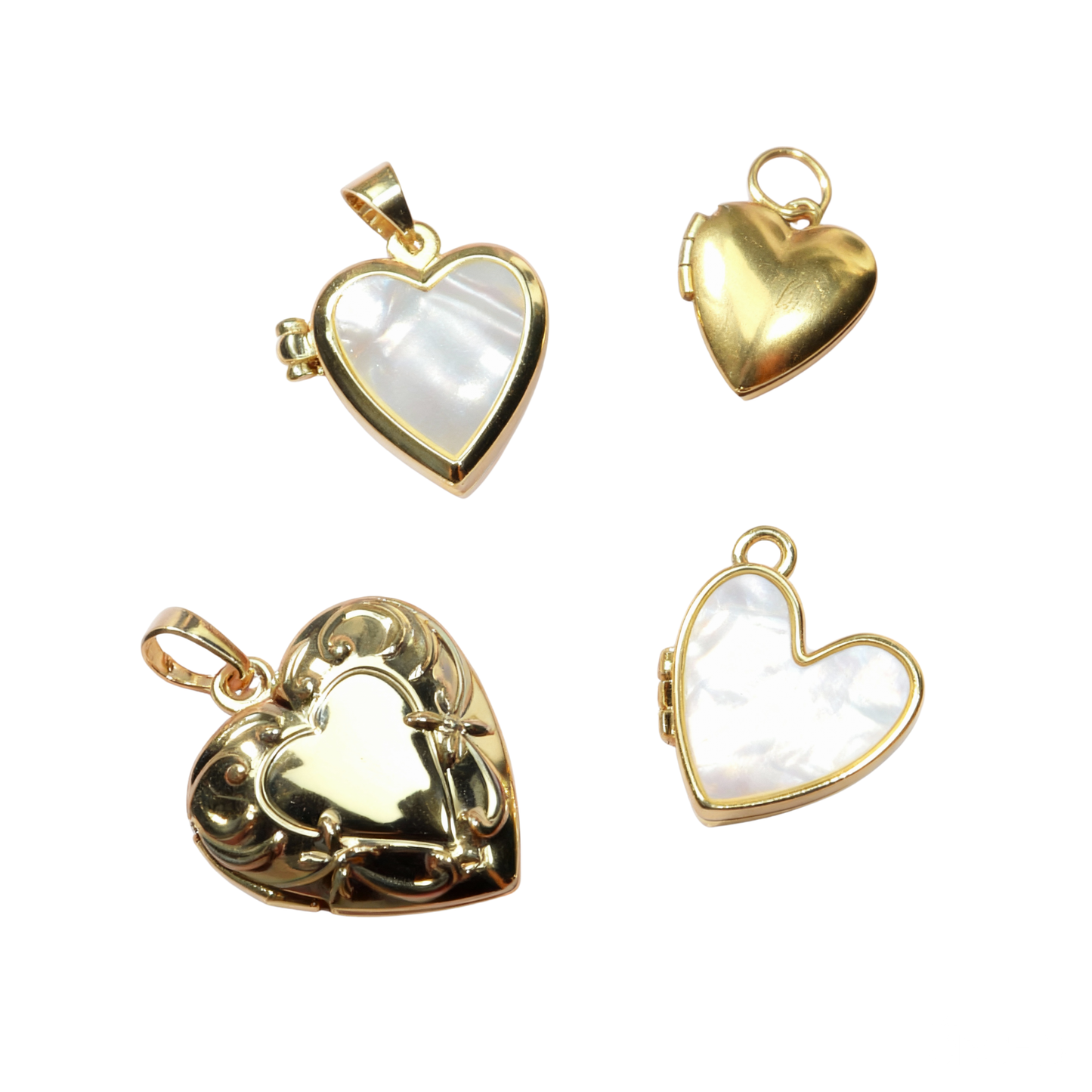 Four gold heart-shaped pendants with white centers on a white background