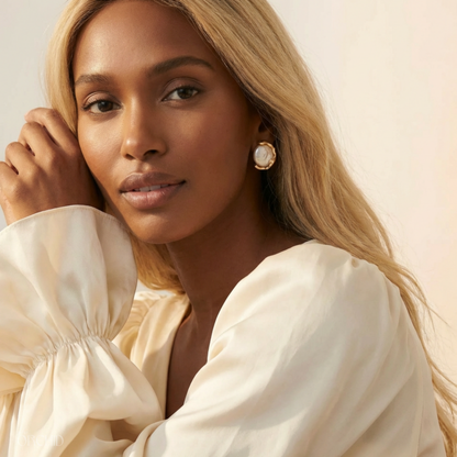 Woman wearing a beige blouse with a soft background