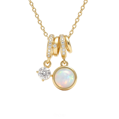 Gold necklace with opal and charm pendants on a white background