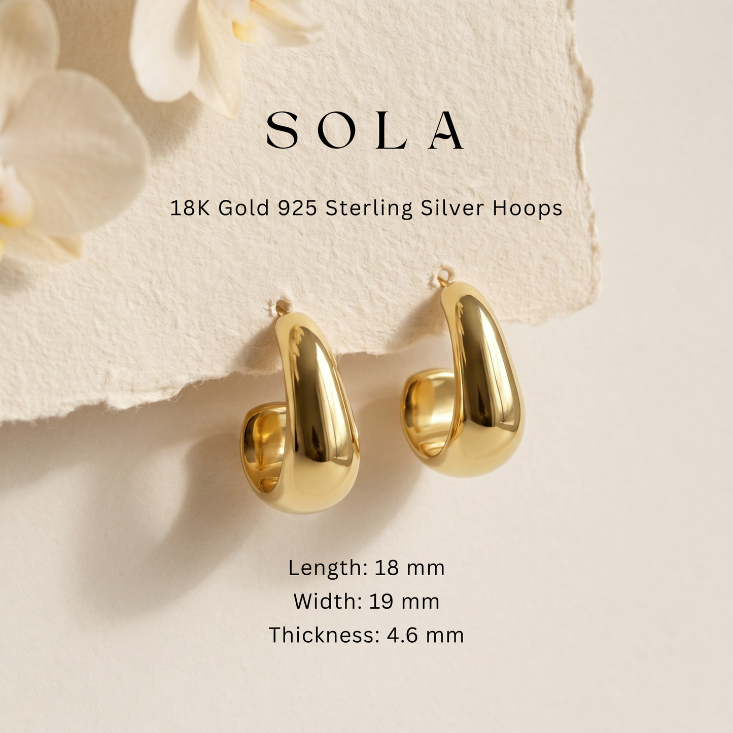 A pair of gold huggie hoop earrings displayed on a textured beige surface with decorative white flowers. Text above reads 'SOLA 18K Gold 925 Sterling Silver Hoops' and text below lists dimensions.