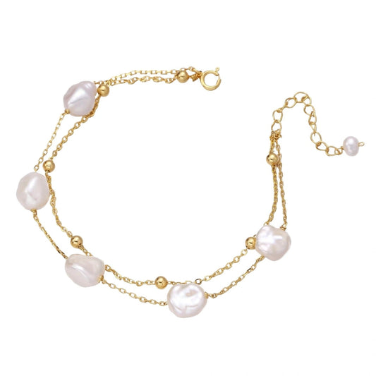 Layered Gold bracelet with baroque freshwater pearls on a white background
