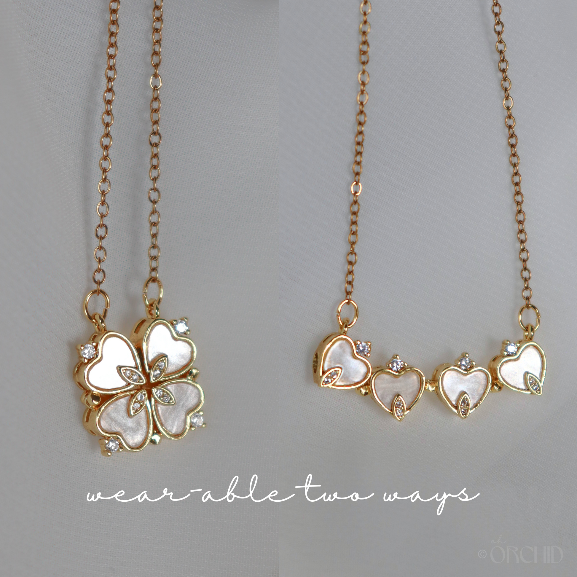 Two gold necklaces with heart designs.
