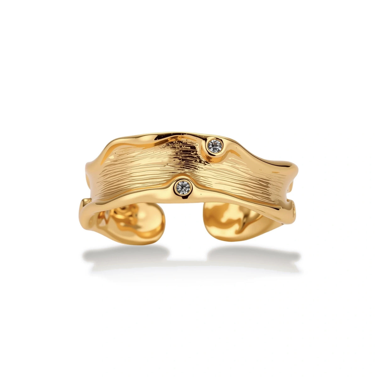 Marisol Flowing Wave Ring, front view of the wavy textured gold-tone band with bezel zirconia accents