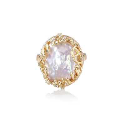 Gold ring with a large pearl stone on a white background