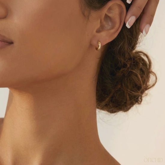 8mm gold hoop earrings on a brunette female.