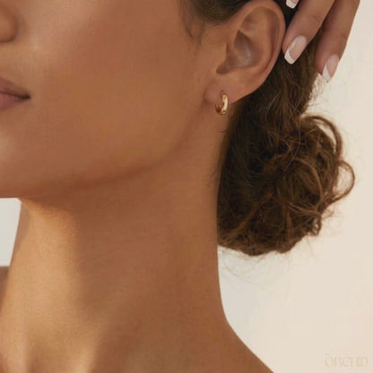 8mm gold hoop earrings on a brunette female.